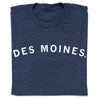 A folded navy blue RAYGUN T-shirt with the text DES MOINES printed in white across the chest.