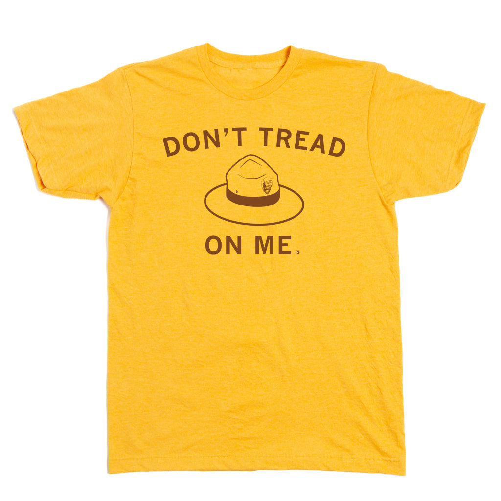 Yellow RAYGUN T-shirt featuring a brown print of a park ranger hat with the text DONT TREAD ON ME.