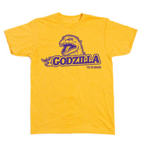 A heather mellow yellow t-shirt with purple ink that says, "Godzilla The OG Dragon" with Godzilla's head emerging above the text.