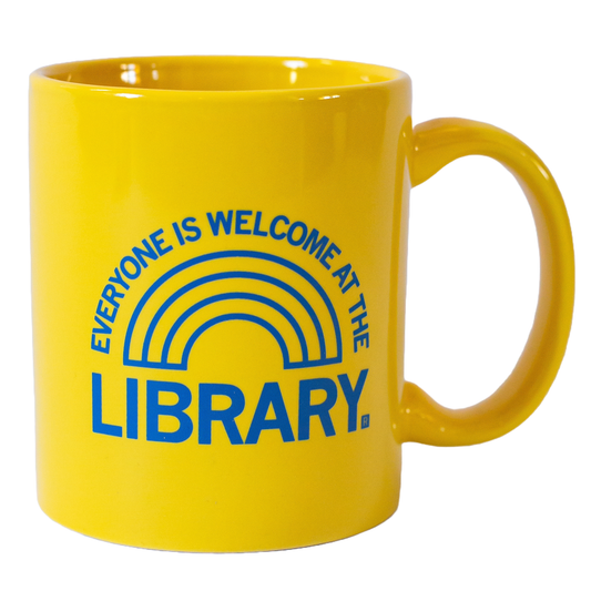 Bright yellow, dishwasher safe mug with blue text that reads EVERYONE IS WELCOME AT THE LIBRARY above a blue rainbow graphic.