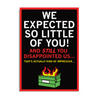 A black postcard with white, red, and gold text that says, "We Expected So Little of You! And STILL you disappointed us... That's actually kind of impressive..." above an illustration of a dumpster fire.