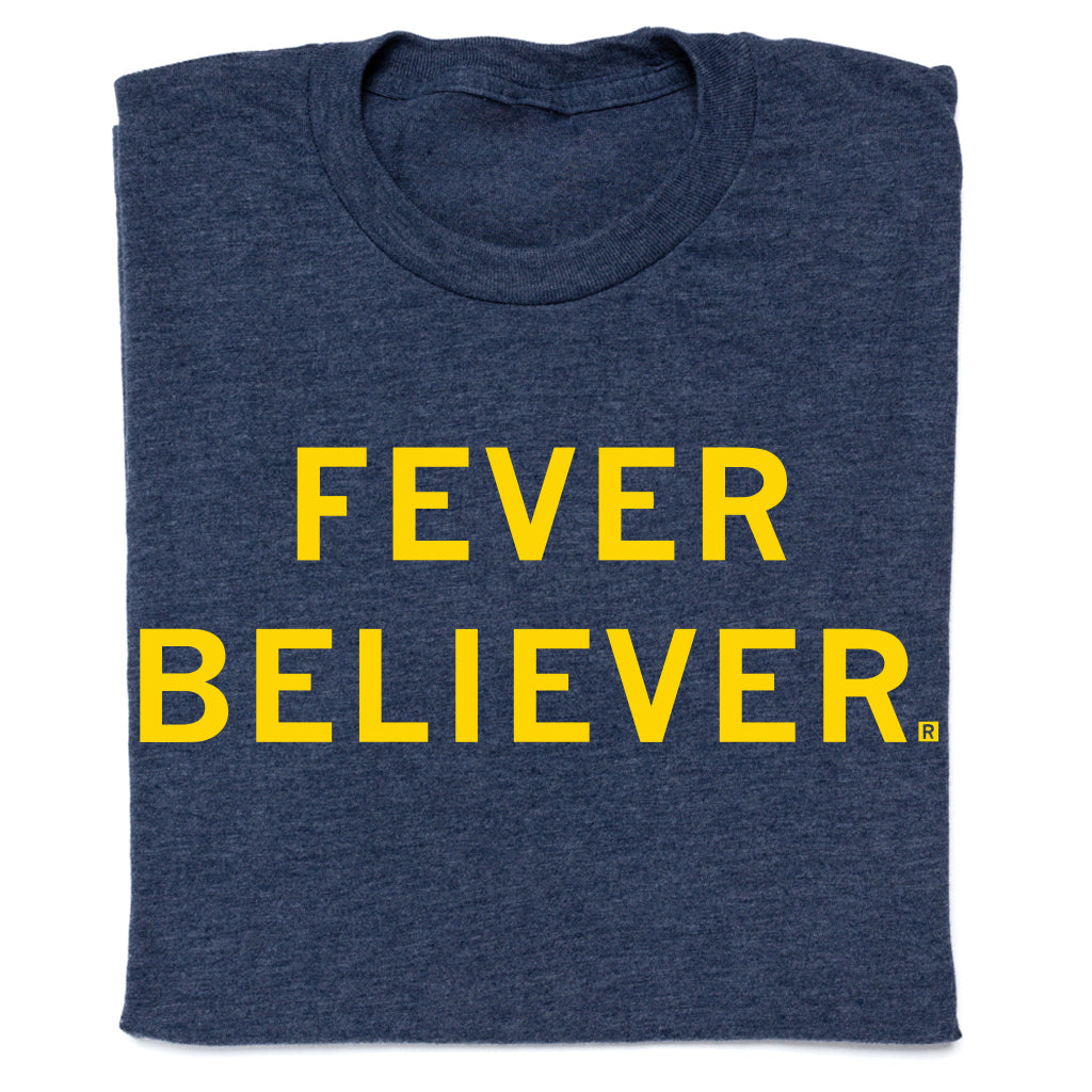 Heather denim t-shirt in navy blue featuring the text FEVER BELIEVER printed in yellow block letters.