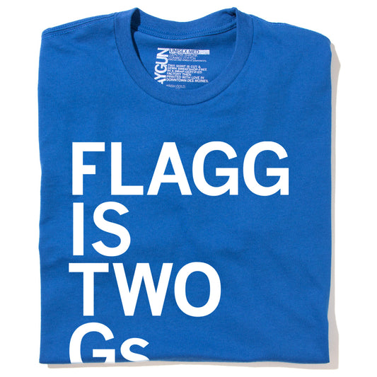 Royal blue RAYGUN T-shirt with the white text FLAGG IS TWO Gs.