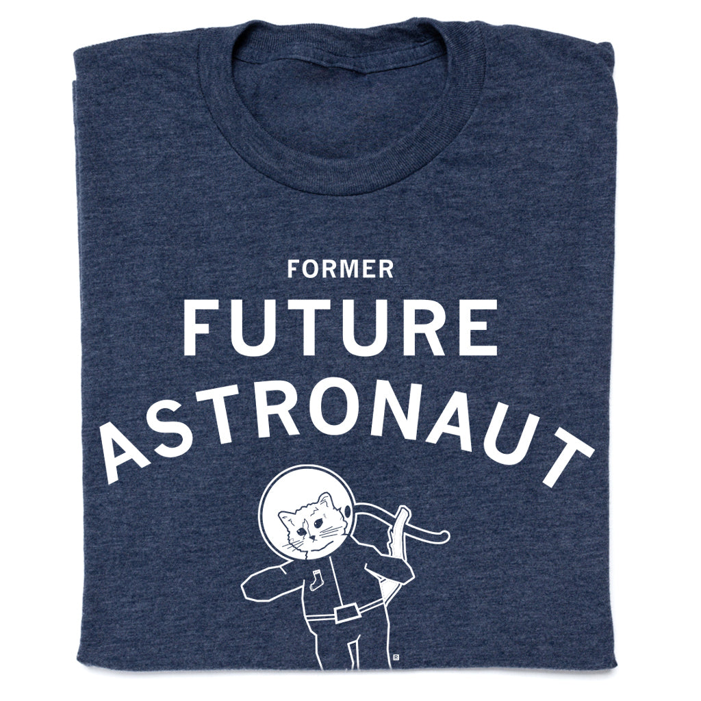 Dark blue RAYGUN apparel t-shirt with text that reads FORMER FUTURE ASTRONAUT above a graphic of a cat wearing a space helmet.