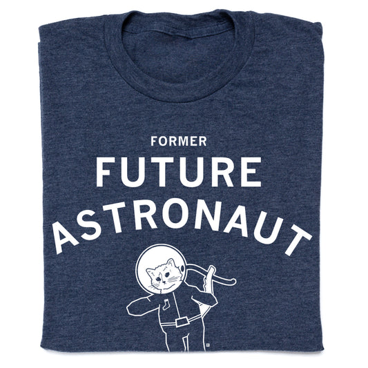 Dark blue RAYGUN apparel t-shirt with text that reads FORMER FUTURE ASTRONAUT above a graphic of a cat wearing a space helmet.