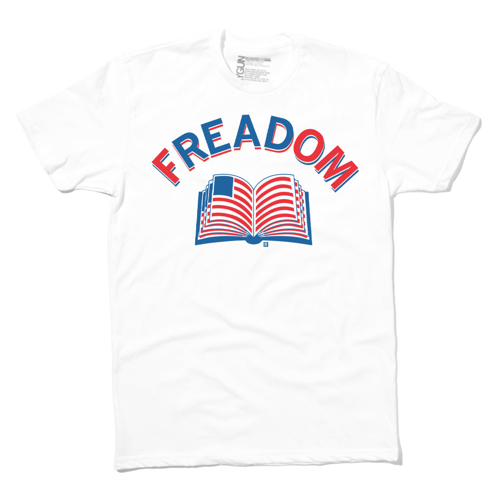 White RAYGUN t-shirt with the text FREADOM arched above an open book featuring an American flag pattern on its pages.