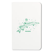 Notebook with kelly green illustration of a cat wearing a cheese hat while riding a musky fish.