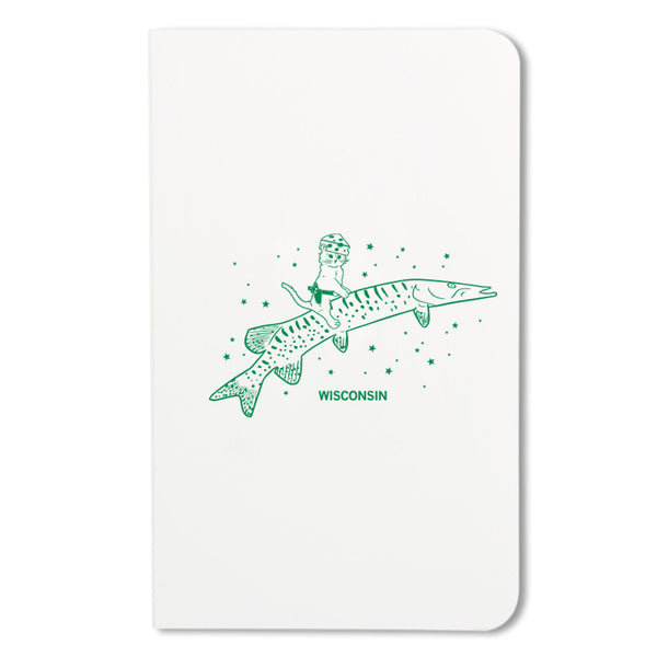 Notebook with kelly green illustration of a cat wearing a cheese hat while riding a musky fish.