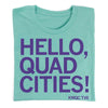 A teal Paula Sands Live t-shirt featuring the purple text HELLO, QUAD CITIES! with KWQC TV6 printed in the bottom right corner.