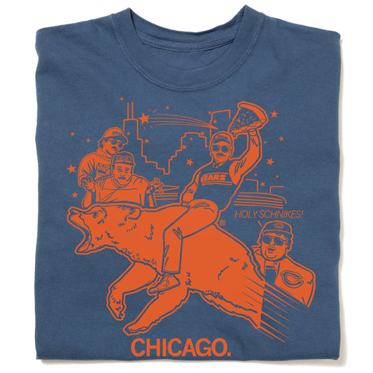 Union-made blue T-shirt featuring an orange graphic of characters riding a bear in front of the Chicago skyline, with the text HOLY SCHNIKES! and CHICAGO.