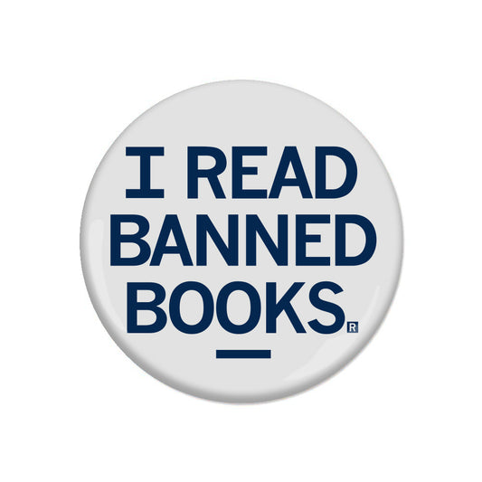 White metal pinback button with the text I READ BANNED BOOKS in dark blue capital letters.