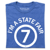 Heather royal blue t-shirt featuring the white text IM A STATE FAIR in a circle around the number 7.
