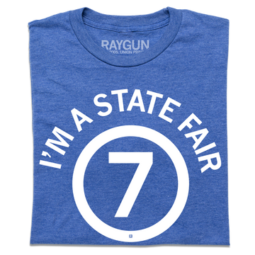 Heather royal blue t-shirt featuring the white text IM A STATE FAIR in a circle around the number 7.