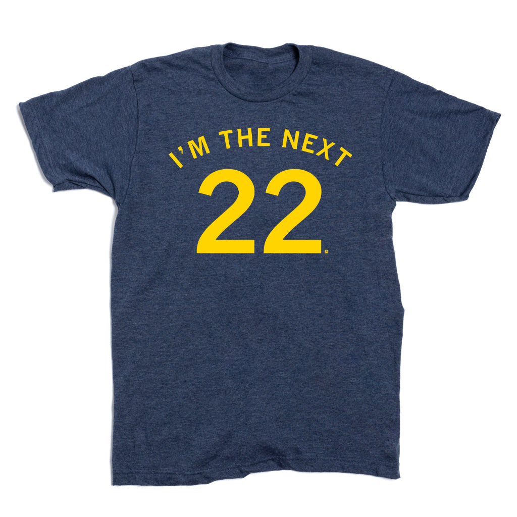 Navy blue RAYGUN crewneck t-shirt with IM THE NEXT 22 printed in yellow text on the chest.