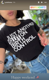 A person wearing a union-made black t-shirt that says JUST ANOTHER SLUT ON BIRTH CONTROL with a hand making a peace sign.