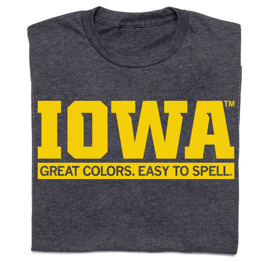 Officially licensed dark gray T-shirt with the word IOWA in large yellow block letters above the text GREAT COLORS. EASY TO SPELL.