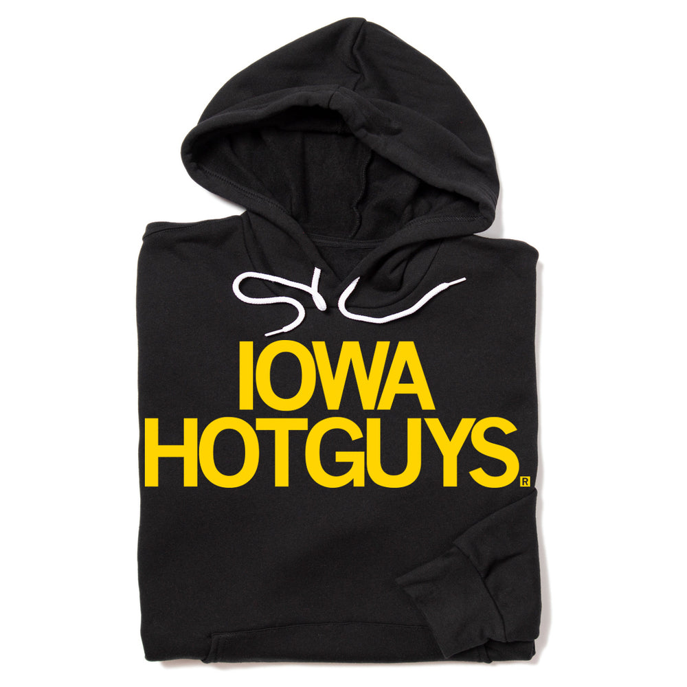 A folded black hoodie with two centered lines of gold text that read "Iowa Hotguys"