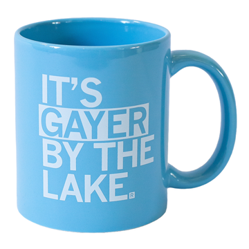 Light blue, dishwasher safe coffee mug featuring the white text, ITS GAYER BY THE LAKE.