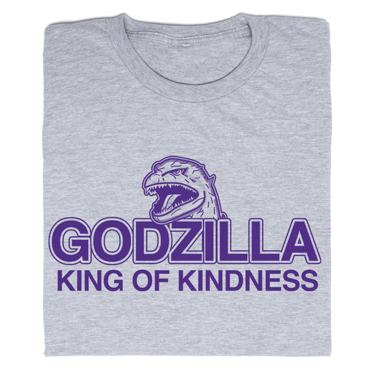 A folded heather grey t-shirt with purple ink that says, "Godzilla King of Kindness" with Godzilla's head emerging above the text.