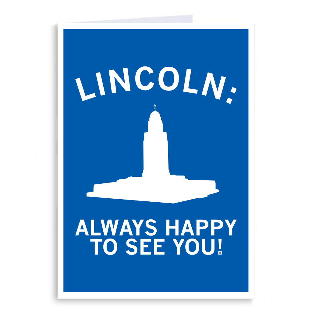 RAYGUN greeting card with a blue background featuring a white silhouette of the Nebraska State Capitol building and the text LINCOLN: ALWAYS HAPPY TO SEE YOU!.