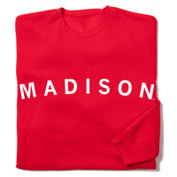 Red sweatshirt with white ink text that reads "Madison"