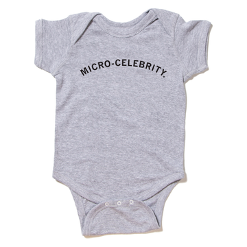 Gray baby Micro-Celebrity onesie with the words printed on the chest.