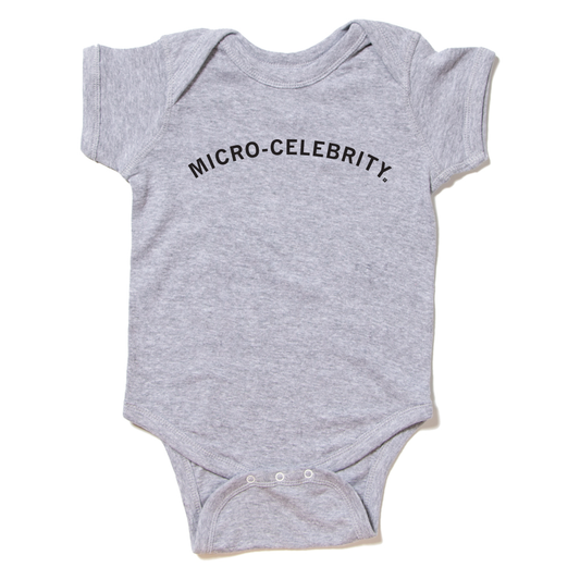Gray baby Micro-Celebrity onesie with the words printed on the chest.