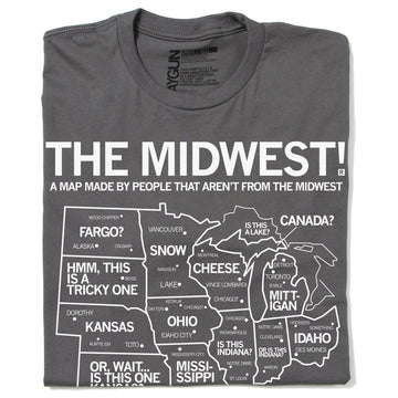 A folded grey t-shirt with white ink depicting a satirical map of the Midwest with text above that reads "The Midwest! A Map Made By People That Aren't From The Midwest"
