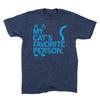 Heather denim, navy blue t-shirt with light blue text that reads MY CATS FAVORITE PERSON, styled with cat ears above the text, a tail to the right, and paw prints at the bottom.