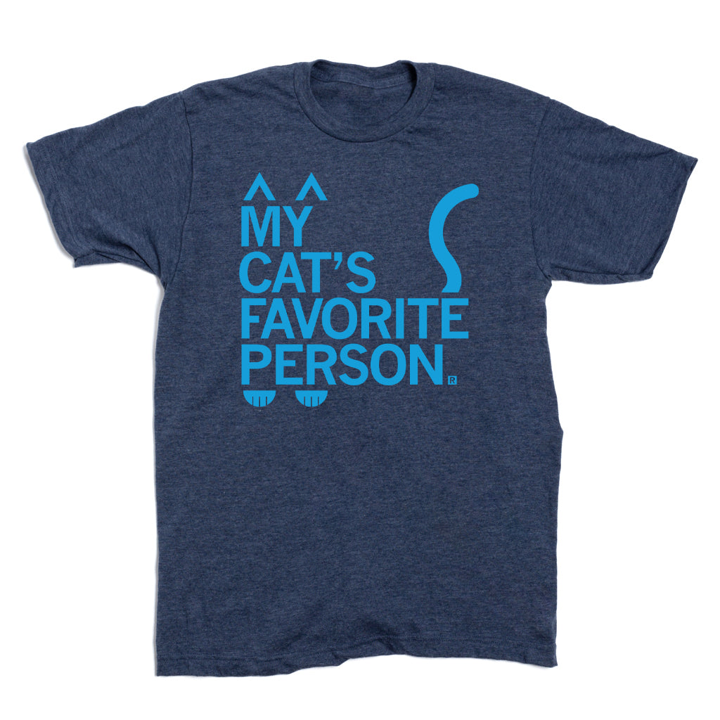 Heather denim, navy blue t-shirt with light blue text that reads MY CATS FAVORITE PERSON, styled with cat ears above the text, a tail to the right, and paw prints at the bottom.