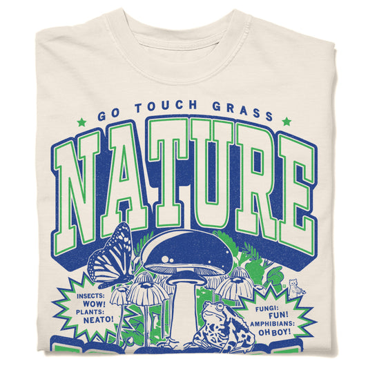 Heavyweight ivory t-shirt featuring a GO TOUCH GRASS NATURE graphic with illustrations of a mushroom, butterfly, and frog, accompanied by text bubbles reading INSECTS: WOW!, PLANTS: NEATO!, FUNGI: FUN!, and AMPHIBIANS: OH BOY!.