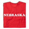 Folded vintage Nebraska red jersey t-shirt with NEBRASKA printed in white distressed lettering across the chest.