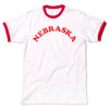 White ringer t-shirt with red trim and the word NEBRASKA printed in red across the chest, celebrating the Cornhusker State.
