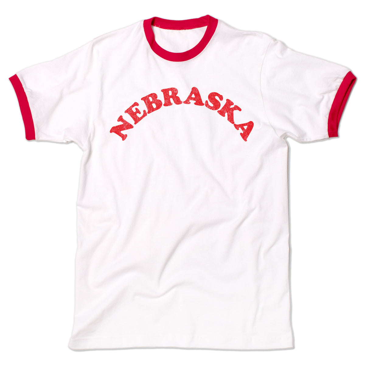 White ringer t-shirt with red trim and the word NEBRASKA printed in red across the chest, celebrating the Cornhusker State.