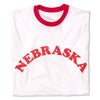 White ringer T-shirt with a red neckline and the word NEBRASKA printed in a red, arched, distressed font across the chest, representing the Cornhusker State.