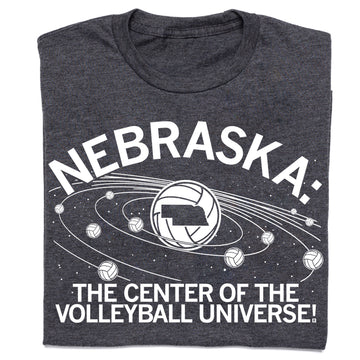 Charcoal T-shirt featuring a volleyball graphic with the state of Nebraska at the center of planetary rings, surrounded by smaller volleyballs and the text NEBRASKA: THE CENTER OF THE VOLLEYBALL UNIVERSE!.
