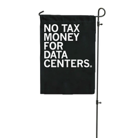 Black garden flag with white ink text that reads "No tax money for data centers."