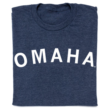 A folded heather denim t-shirt with OMAHA printed in white capital letters across the chest.
