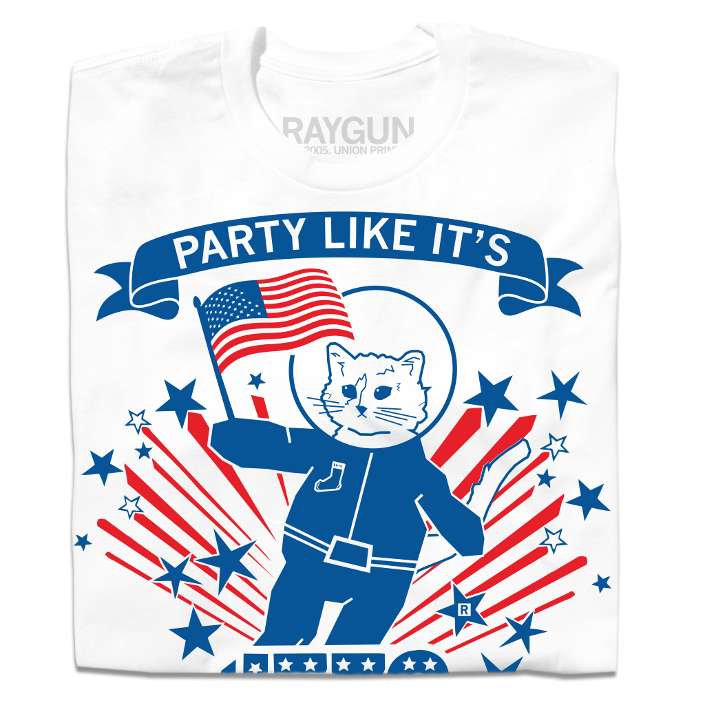 A white, union-made t-shirt featuring an astronaut cat in a spacesuit holding an American flag. It is surrounded by blue stars and red and blue sunburst lines, with PARTY LIKE ITS on a banner above this patriotic RAYGUN design.