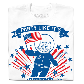 A white, union-made t-shirt featuring an astronaut cat in a spacesuit holding an American flag. It is surrounded by blue stars and red and blue sunburst lines, with PARTY LIKE ITS on a banner above this patriotic RAYGUN design.