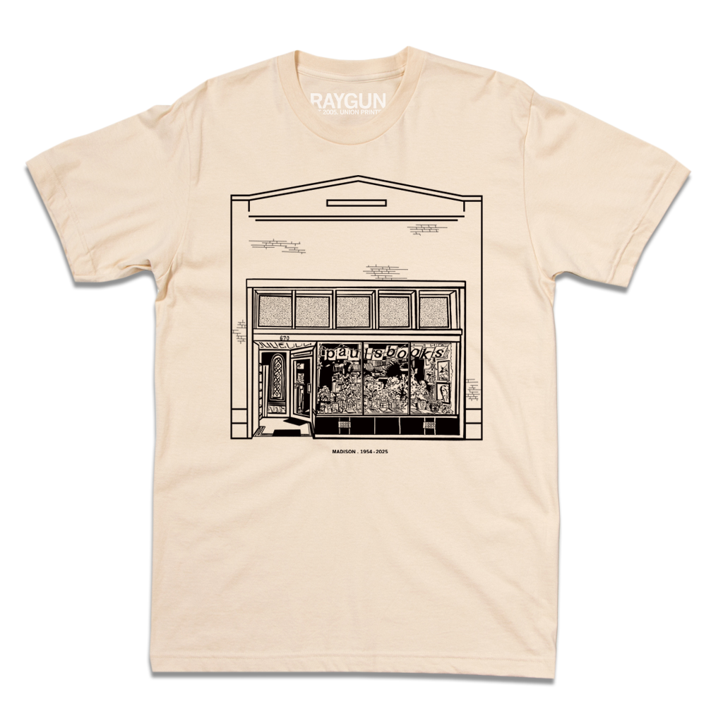 Heavyweight ivory t-shirt featuring a black line drawing of the Paul’s Book Store storefront with the text MADISON 1954-2025 below it.