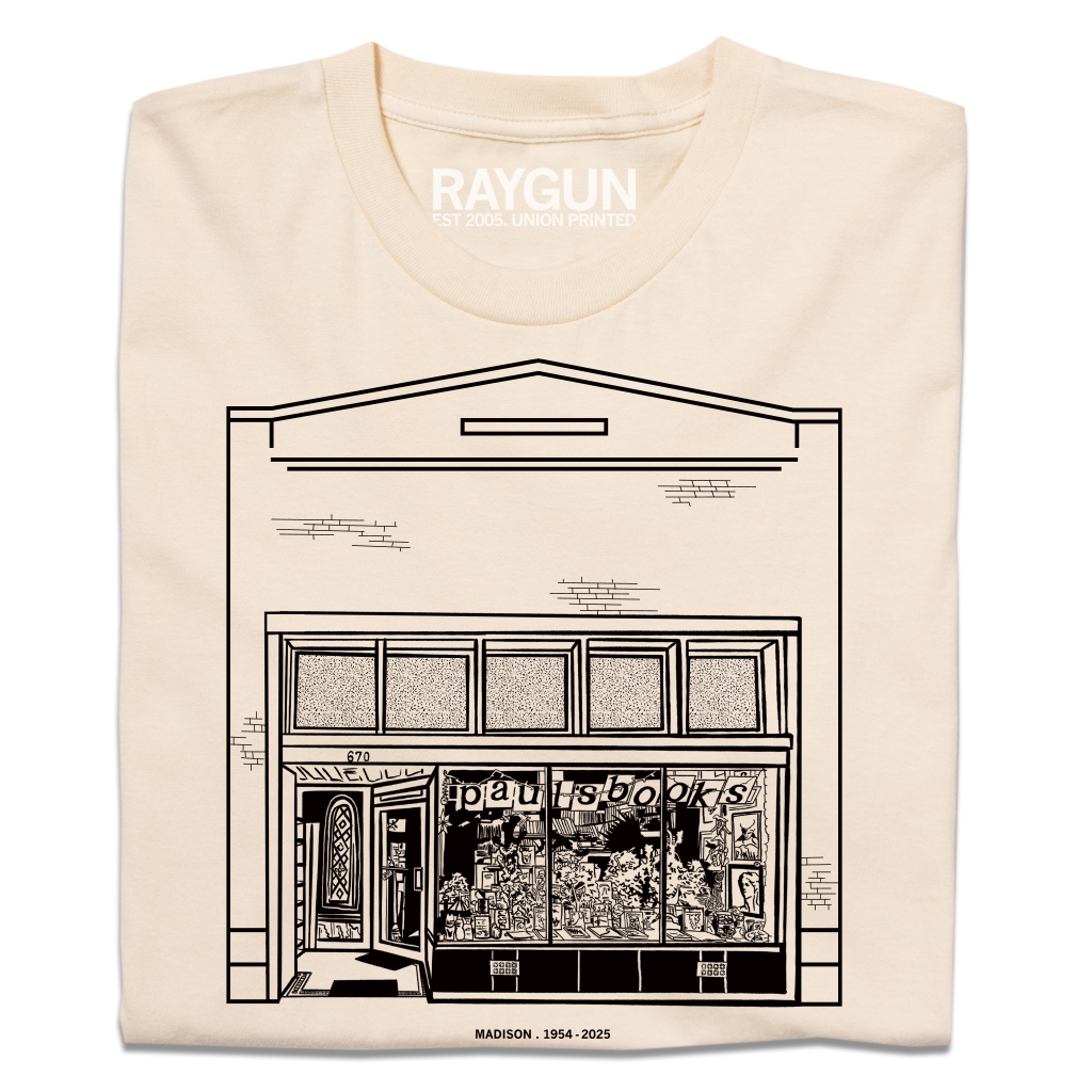 Heavyweight ivory t-shirt featuring a black line drawing of the Paul’s Book Store storefront with the text MADISON . 1954 - 2025 below.