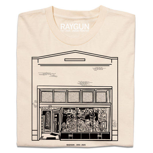 Heavyweight ivory t-shirt featuring a black line drawing of the Paul’s Book Store storefront with the text MADISON . 1954 - 2025 below.
