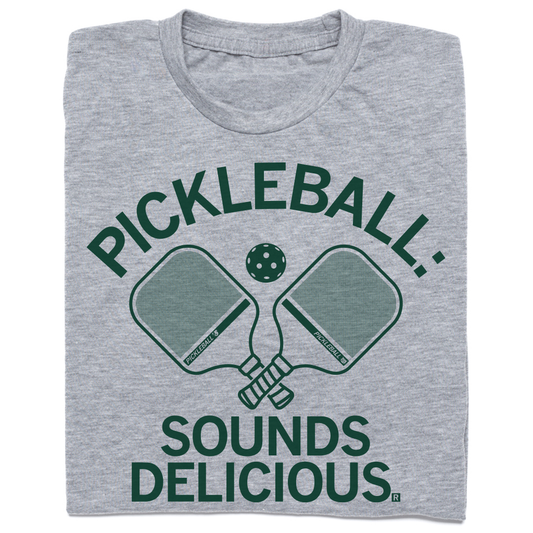 Heather grey t-shirt featuring two pickleball paddles, a pickleball, and the text PICKLEBALL: SOUNDS DELICIOUS.