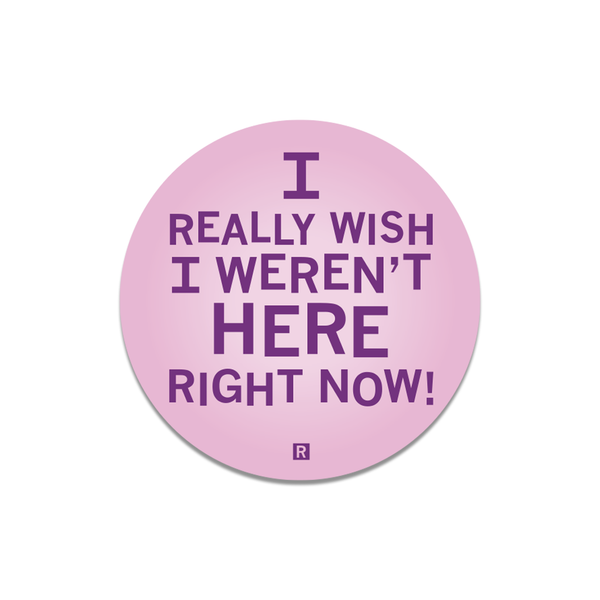 A pink circular sticker with purple text that says, 