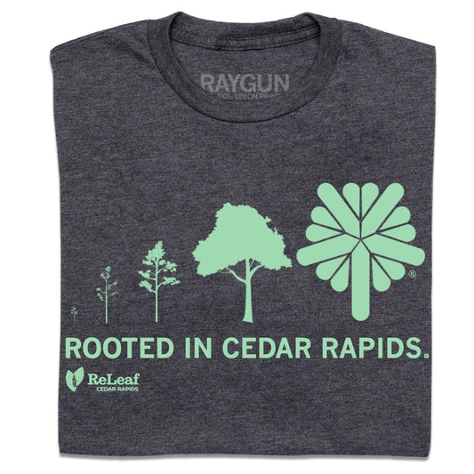 Charcoal grey union labor t-shirt featuring a graphic that shows the growth of a tree from a seedling to a stylized icon, with the text ROOTED IN CEDAR RAPIDS and the ReLeaf Cedar Rapids logo below.