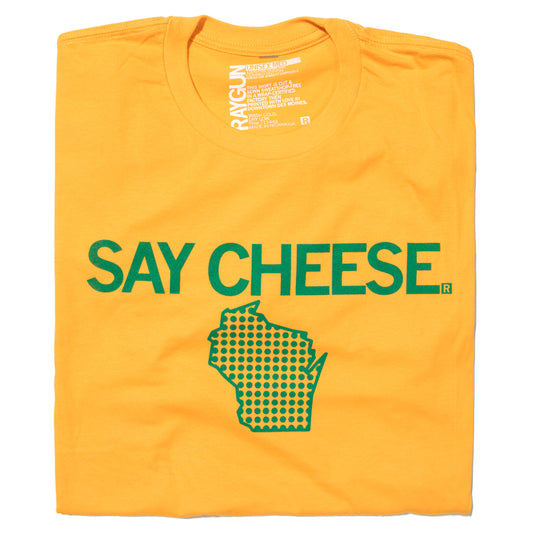 Gold T-shirt featuring the text SAY CHEESE in green above a green dot-patterned outline of Wisconsin.