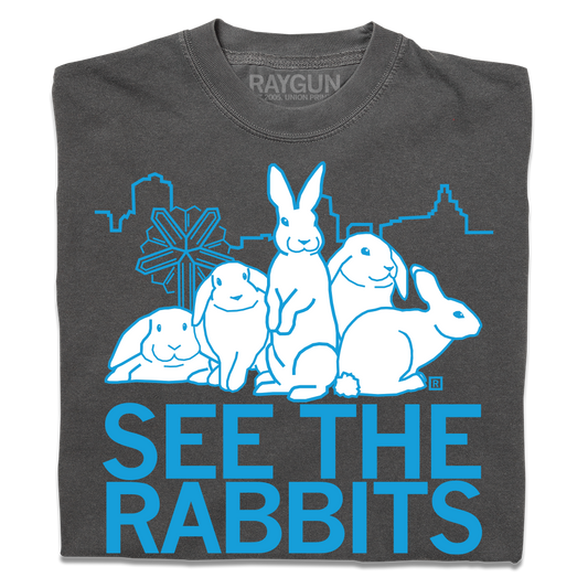 Heavyweight charcoal gray T-shirt with a blue graphic of four rabbits in front of a city skyline, featuring the text SEE THE RABBITS.