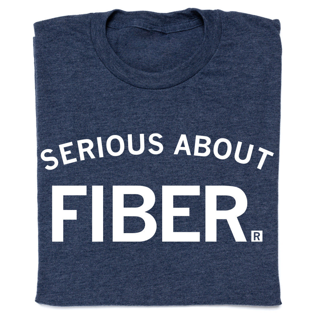 A heather denim crewneck t-shirt in dark blue with the text SERIOUS ABOUT FIBER. printed in white.