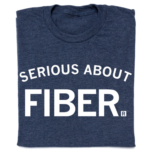 A heather denim crewneck t-shirt in dark blue with the text SERIOUS ABOUT FIBER. printed in white.
